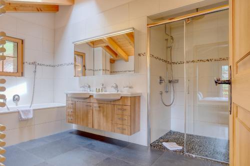 a bathroom with a sink and a shower at Apartment Bränderli - GRIWA RENT AG in Grindelwald