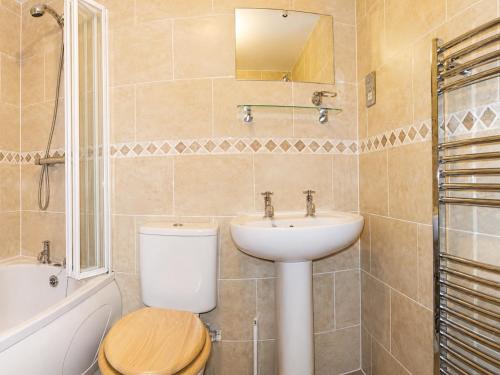 a bathroom with a toilet and a sink at Endeavour Cottage Whitby Quiet Old Yard Fishermans Cottage in Whitby