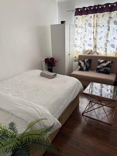 a bedroom with a large bed and a couch at Cottingley Spring farm house in Leeds