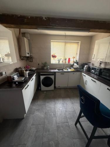 a small kitchen with a sink and a dishwasher at Cottingley Spring farm house in Leeds