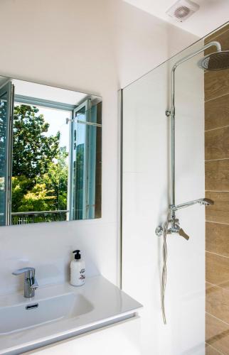 a bathroom with a sink and a mirror at A Calexa Sarria nº3 in Sarria