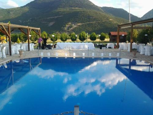 a view of the pool at a resort with mountains in the background at Ktima Kletsa in Graviá