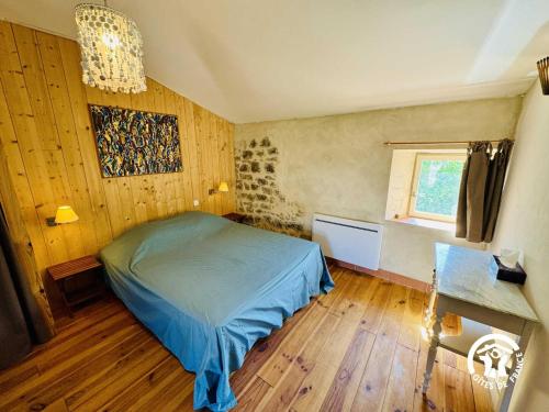 a bedroom with a bed and a window at Gîte de la jument rousse in Lagrasse