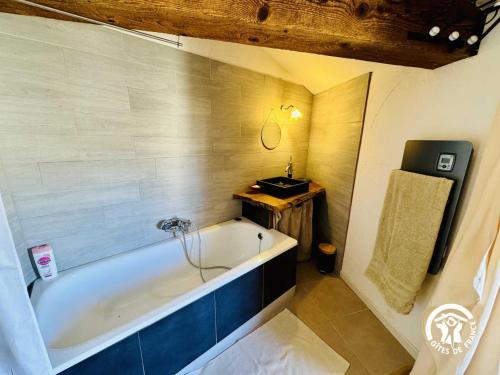 a bathroom with a bath tub and a sink at Gîte de la jument rousse in Lagrasse