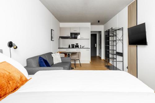 a bedroom with a bed and a living room at Global Living Passau Ludwigplatz in Passau