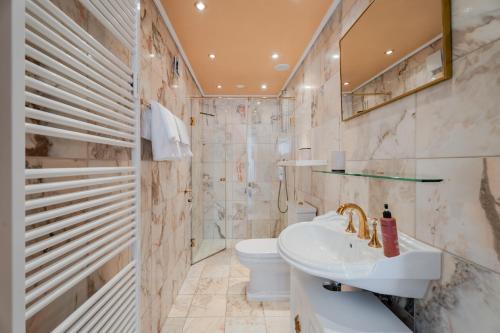 a bathroom with a sink and a toilet at Rai Mattiss in Oberharmersbach