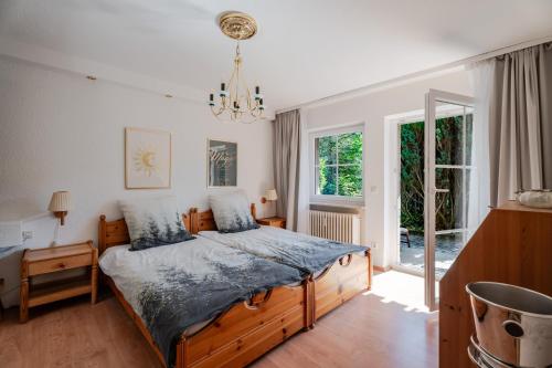a bedroom with a bed and a chandelier at Rai Mattiss in Oberharmersbach