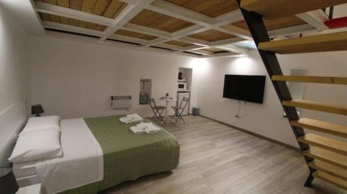 a bedroom with a large bed and a loft at Mastropaolo42 Luxury B&B in Grottaglie