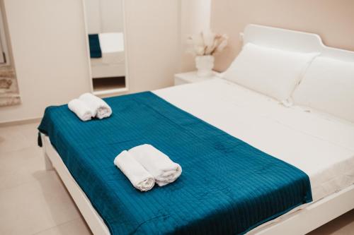 two towels sitting on a bed in a bedroom at Corte Altobelli Rooms Bitonto in Bitonto