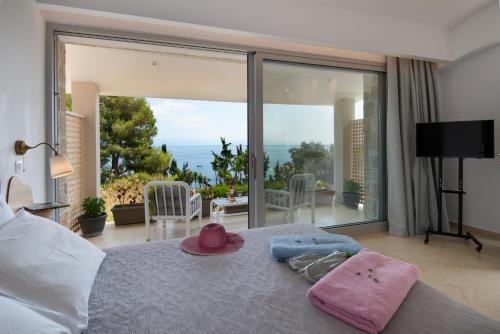 a bedroom with a bed with a view of the ocean at Villa Baronnos in Gaios