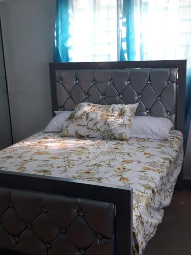 a bed with a metal headboard and pillows on it at SDQ apartamentos in Cancino