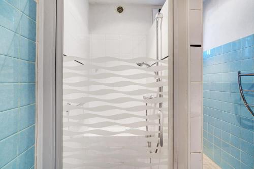 a bathroom with a walk in shower next to a glass shower door at Maison De Campagne in Ligneyrac