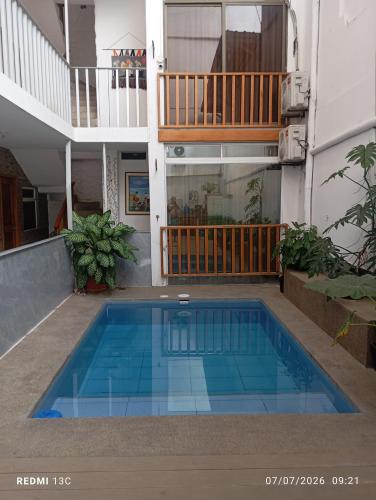 a swimming pool in the middle of a building at Yemayá hostal in Puerto López