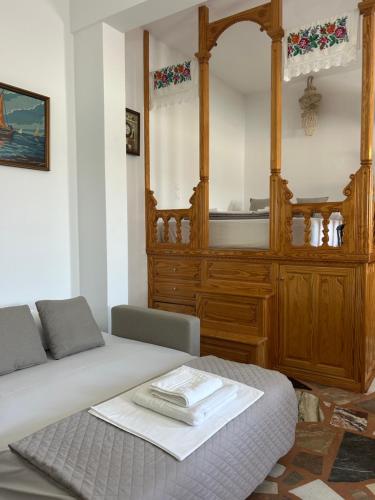 a bedroom with a bed and a wooden cabinet at Antiperatos Beach house in Karpathos