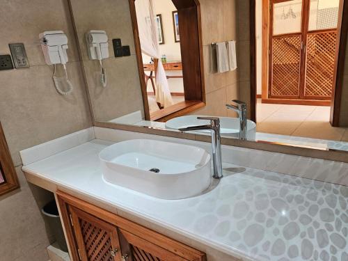 a bathroom with a sink and a mirror at Kilima Safari Camp in Amboseli