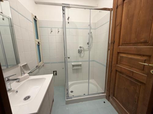 a bathroom with a shower and a sink and a glass door at Marinella Retreat - Brezza in Zambrone