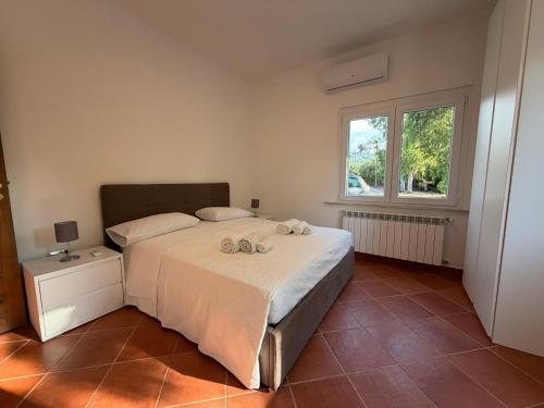 a bedroom with a bed with two towels on it at Marinella Retreat - Brezza in Zambrone
