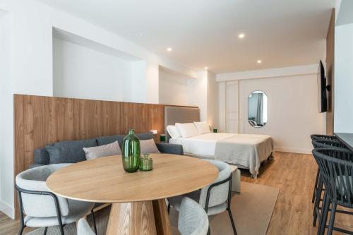 a hotel room with a couch and a table and a bed at Cauce 4 Apartments in Torremolinos