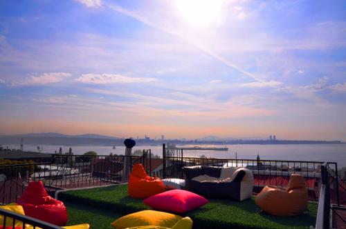 a group of chairs sitting on the grass near the water at Angel's Home Hotel - Angel Group Hotels in Istanbul