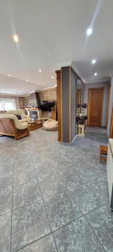 a large living room with a large tile floor at Apartamento Camariñas in Camariñas