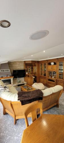 a large living room with a couch and a table at Apartamento Camariñas in Camariñas