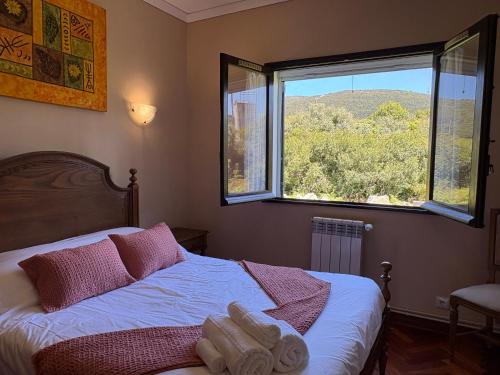 a bedroom with a bed and a large window at Moledo Seaview in Moledo