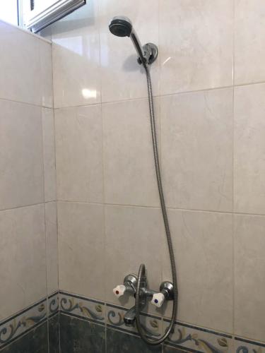 a shower in a bathroom with a shower head at Къща Йорданови in Chernomorets