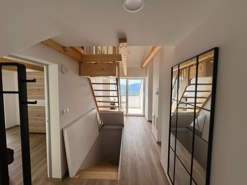 a hallway of a house with a staircase and a door at Apartma Pr`mejač in Laze v Tuhinju
