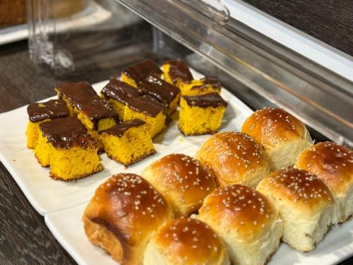a plate of buns and desserts on a table at Hotel Ciudad Nueva in Ciudad del Este
