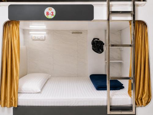 a bunk bed with a ladder in a room at Andheri-69-Dormitory in Mumbai