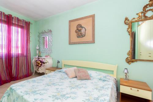 a bedroom with a bed and a mirror at Casa Pia in Valledoria