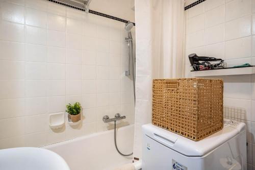 a bathroom with a toilet and a basket on top of it at Ferienappartement in Black Forest in Baiersbronn
