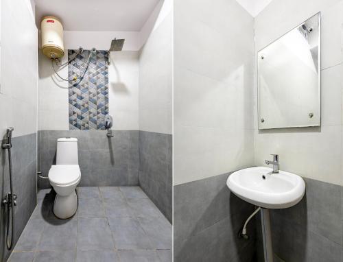 a bathroom with a toilet and a sink at Hotel Aditya Premier in Guntūr