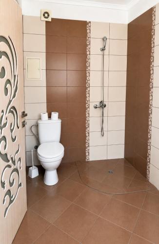a bathroom with a toilet and a shower at Vanilla Garden Apartments in Sunny Beach