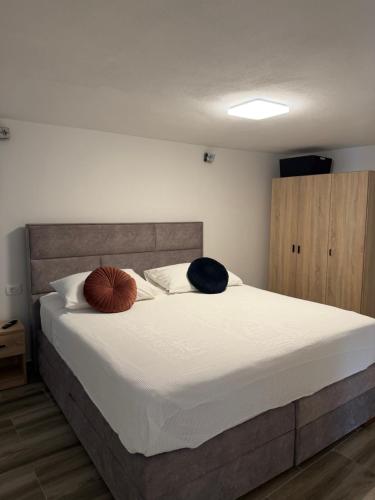 a bedroom with a bed with two pillows on it at Apartmani Brač in Pučišća