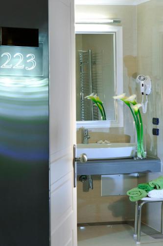 a bathroom with a sink and a mirror at Demetra Hotel in Rome
