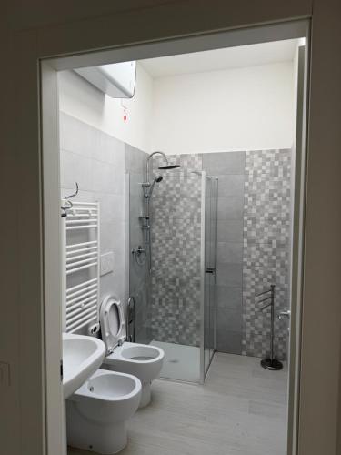 a bathroom with two toilets and a shower at Artexia residence DIAMANTE A1 in Valenza