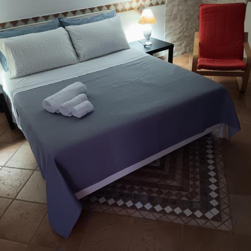 a bedroom with a bed with two towels on it at Domus Liberty Luxury House in Sala Consilina