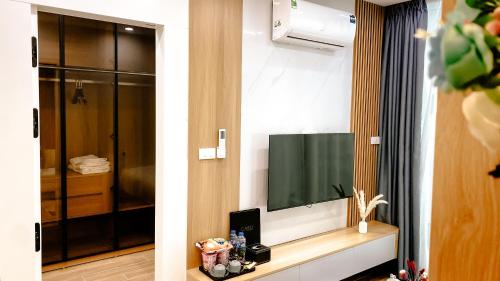 a room with a flat screen tv on a wall at Caelistay in Hanoi