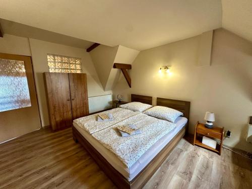 a bedroom with a large bed in a attic at Mendi in Štúrovo