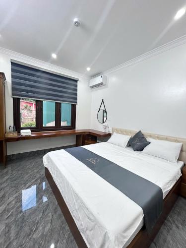 a bedroom with a large bed and a window at Cloudy Hotel in Ha Giang