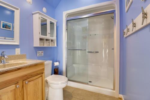 a bathroom with a toilet and a glass shower at Pool, Dock + Rooftop Views! Bohannon Getaway in Bohannon