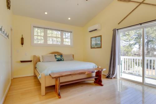 a bedroom with a bed and a window at Pool, Dock + Rooftop Views! Bohannon Getaway in Bohannon