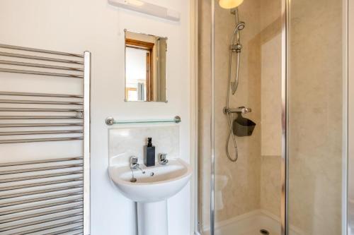 a bathroom with a sink and a shower at 3 Bed in Whitchurch Canonicorum oc-43395 in Whitchurch Canonicorum