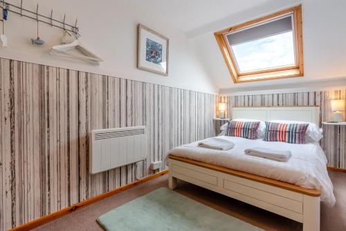 a bedroom with a bed and a window at 5 Bed in Beadnell oc-24955 in Beadnell