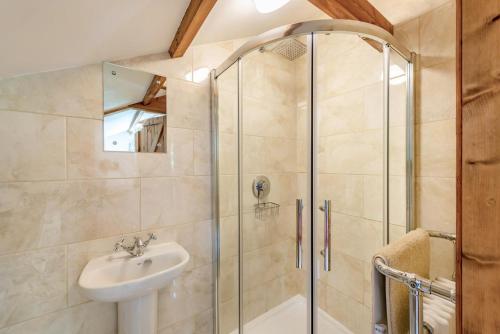 a bathroom with a shower and a sink at 3 Bed in Chulmleigh oc-87779 in Eggesford