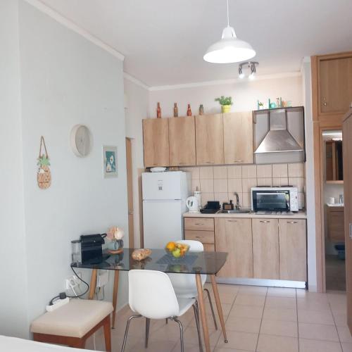 a kitchen with a table and chairs and a refrigerator at Studio Nicki Chania in Chania
