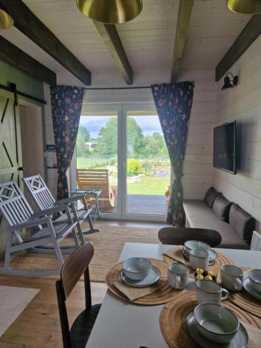a living room with a couch and a table at Otwarte Okiennice Soce 74 in Soce
