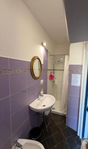 a bathroom with a sink and a shower and a toilet at B&B Al Bricco in Albisola Superiore