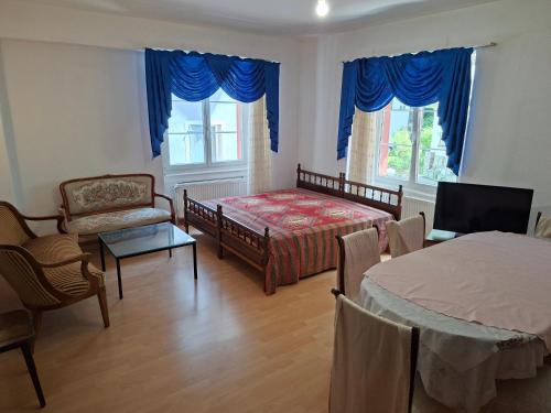 a bedroom with a bed and a table and chairs at Braui Pub and Restaurant in Waldenburg